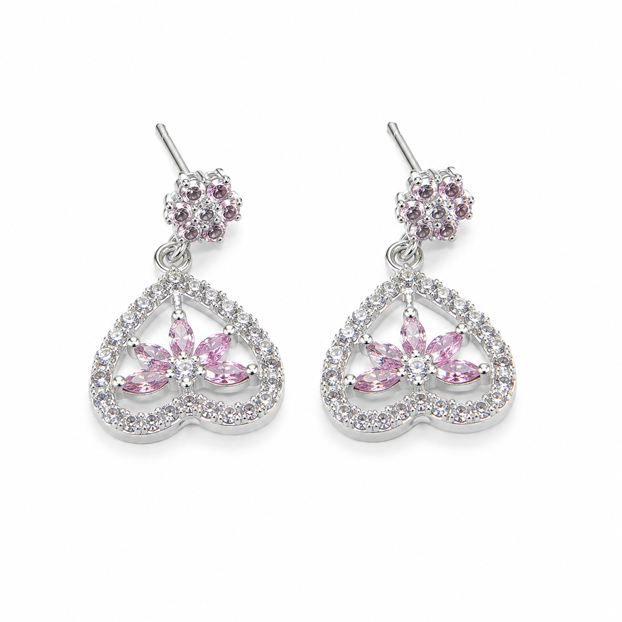 A pair of silver-toned dangle earrings featuring a small round cluster of pink stones at the top and a larger open heart-shaped drop with a central pink floral motif surrounded by clear stones, shown on a plain white background.