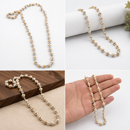 A beaded chain necklace with alternating metallic gold and cream beads, shown in four views: on a white background, draped over a white cylinder, on a wooden surface, and draped over a hand to show scale.